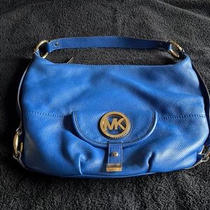 Vintage Michael Kors bag. Pockets on outside and zipper pocket on inside.